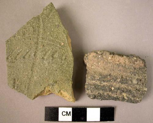 2 potsherds -- 1 with gooving, 1 with an incised pattern