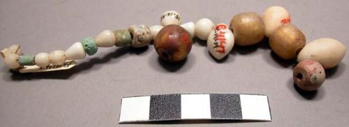 Glass beads, round, clear with light bronze interior, others natrolite