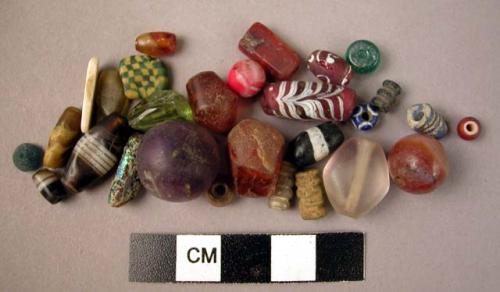 Bottle of stone, glass, & shell beads