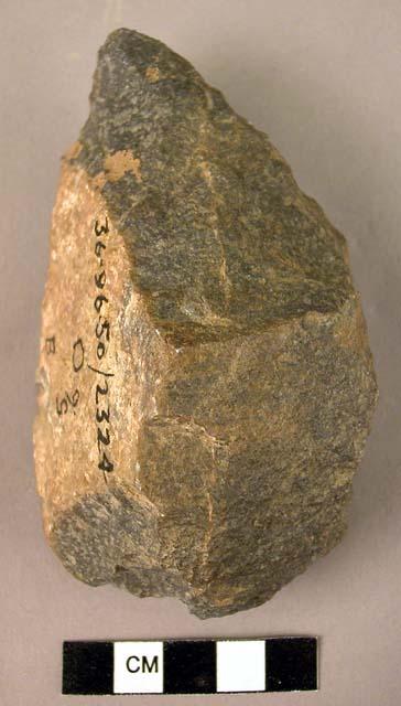 Small quartzite fist axe chipped to a triangular point