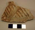 Plain corrugated potsherd with design in diagonal smooth band