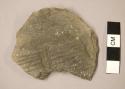 Ceramic sherd, indentations and parallel incised designs