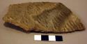 Corrugated potsherd with corrugations partly obliterated