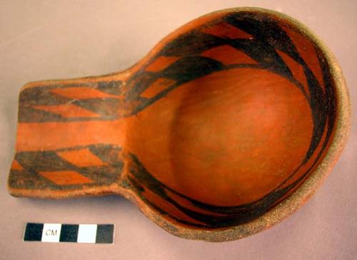 Black on red pottery ladle