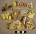 27 potsherds - glazed, painted with white, yellow and dark brown (local)