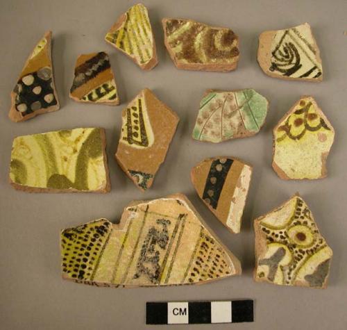 27 potsherds - glazed, painted with white, yellow and dark brown (local)