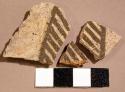 Ceramic body sherd, black on white linear designs