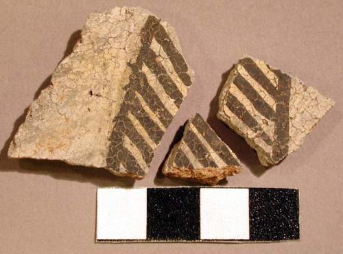 Ceramic body sherd, black on white linear designs