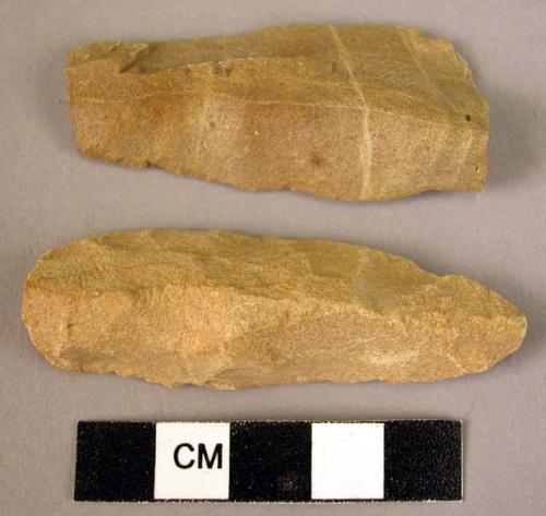 2 fine-grain sandstone long, narrow blades showing signs of use