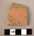 Ceramic rim sherd, red ware with black painted geometric design