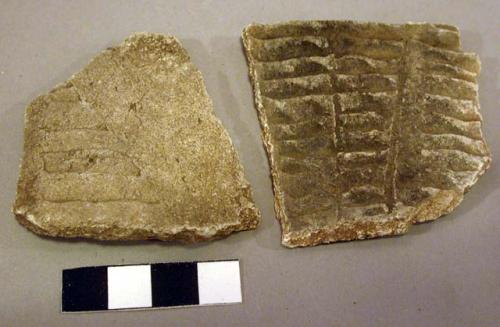 Corrugated potsherds with incised lines and smoothed sections