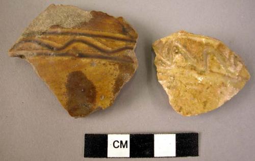 2 potsherds - yellow-brown glaze (local)