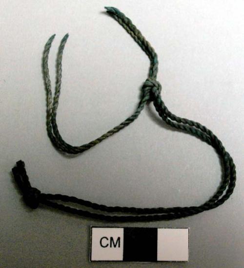 Cord fragment, twisted vegetable fiber, black, knotted double strand