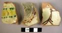 3 base potsherds - lead glaze, cream brown and green painted patterns (local)