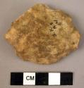 Small disc-shaped quartzite flake used for scraping