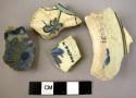 4 potsherds - blue and black on white glaze