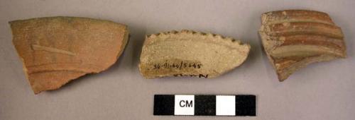 2 rim potsherds - red, incised