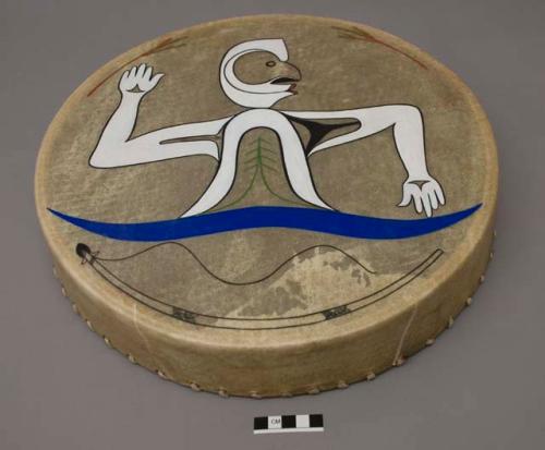 Drum painted with white figure over unstrung bow