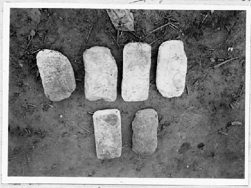 Manos, upper (lower) two from bottom of cist in room 2.