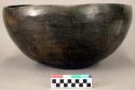 Ceramic bowl, black burnished exterior, flat base
