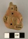 Clay trophy-head whistle with incised motifs