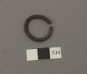 Metal ring, C-shaped, grooved perimeter, slightly corroded