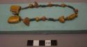 Cast of necklace consisting of amber, tin and faience beads