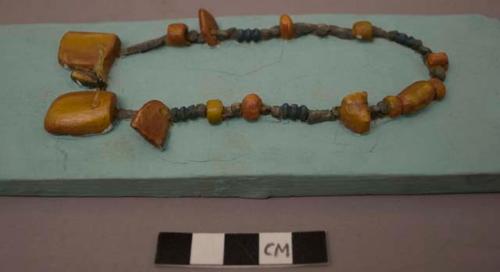 Cast of necklace consisting of amber, tin and faience beads