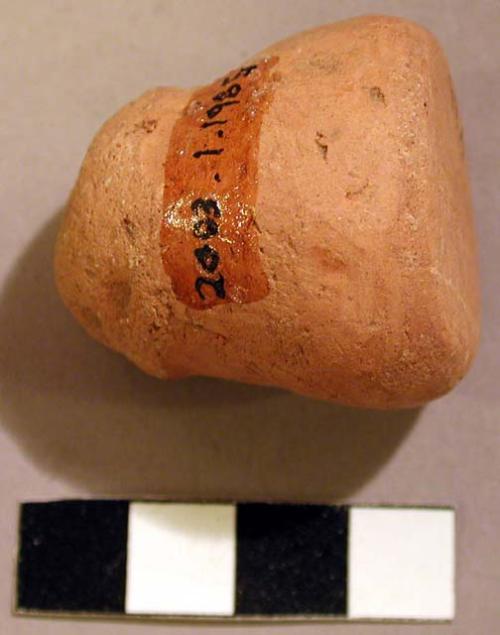 Ceramic handle fragment, 1 side flattened, conical, undecorated