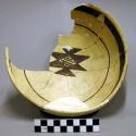 Ceramic partial bowl, flared rim, brown on yellow, reconstructed