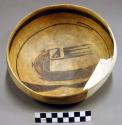 Black on yellow pottery bowl, restorable