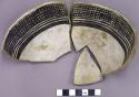 Black on white cup sherds with a loop handle and interior crosshatch