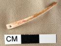 Bone needle, complete, with perforation at one end, tapers in width from head to