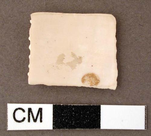 Shell fragment, carved into square shape