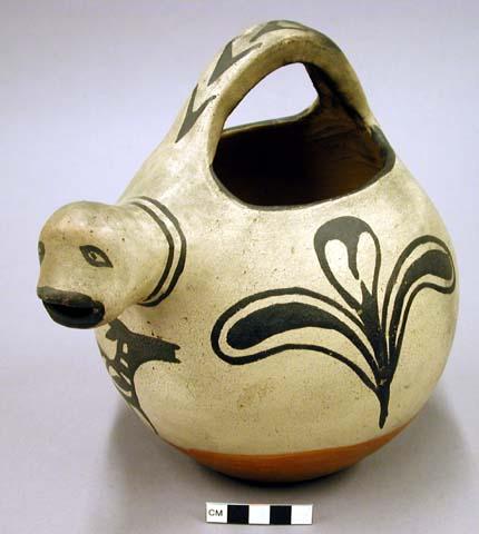 Painted pottery vessel with handle and effigy spout.