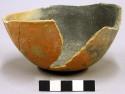 Bowl. hemispherical; flattened base; rim chipped; body repaired; sherds remain m