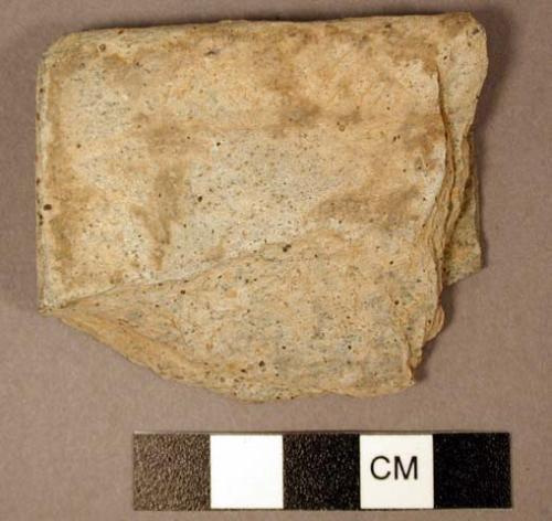 Palette fragment, 1 corner. slightly raised border with incised design. schist.