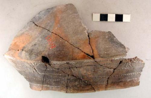 Ceramic rim sherd, incised decoration around rim, mended, plastic display piece