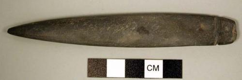 Probable stone awl, long, highly polished pointed implement, lateral groove exte