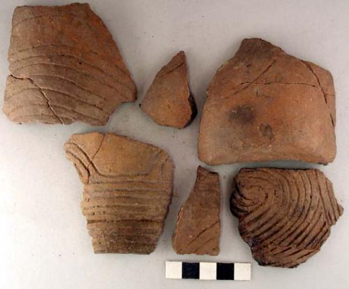 Ceramic body sherds, incised curvalinear design, mended