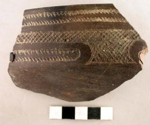 Ceramic rim sherd, black, incised linear and crosshatch design