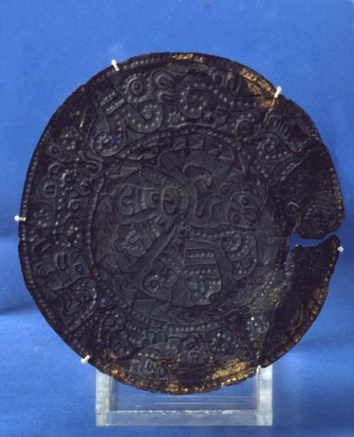 Embossed disc with bird head