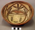 Pottery bowl - brown and red on buff; face in bottom of bowl