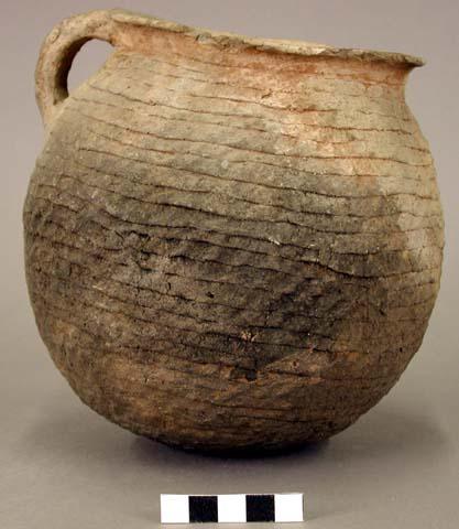 Ceramic jar, corrugated, flared rim, incised handle, cracked