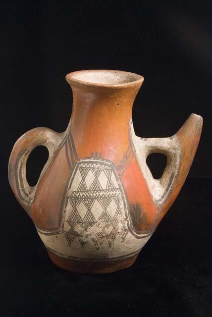 Red pitcher with spout and handle