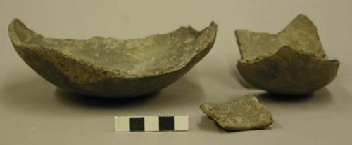 Ceramic base of partial vessel, body fragment repaired and sherds