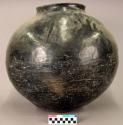 Large pottery storage jar. Globular, small orifice, short straight rim wound