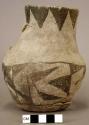 Ceramic pitcher, black on white exterior, broken handle, flared neck