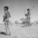 Two boys carrying bows and quivers