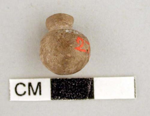 Stone object, appears to be miniature jar made from lithic material, spherical w
